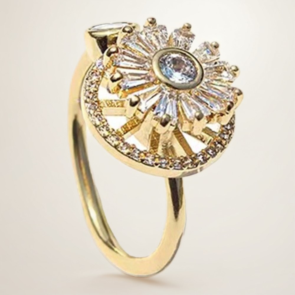 Sunburst Spinner Ring: a sunburst of clear baguette stones that spins freely inside a halo of small stones